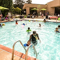Residents in the pool at The Crossings at Glassboro Apartments.
