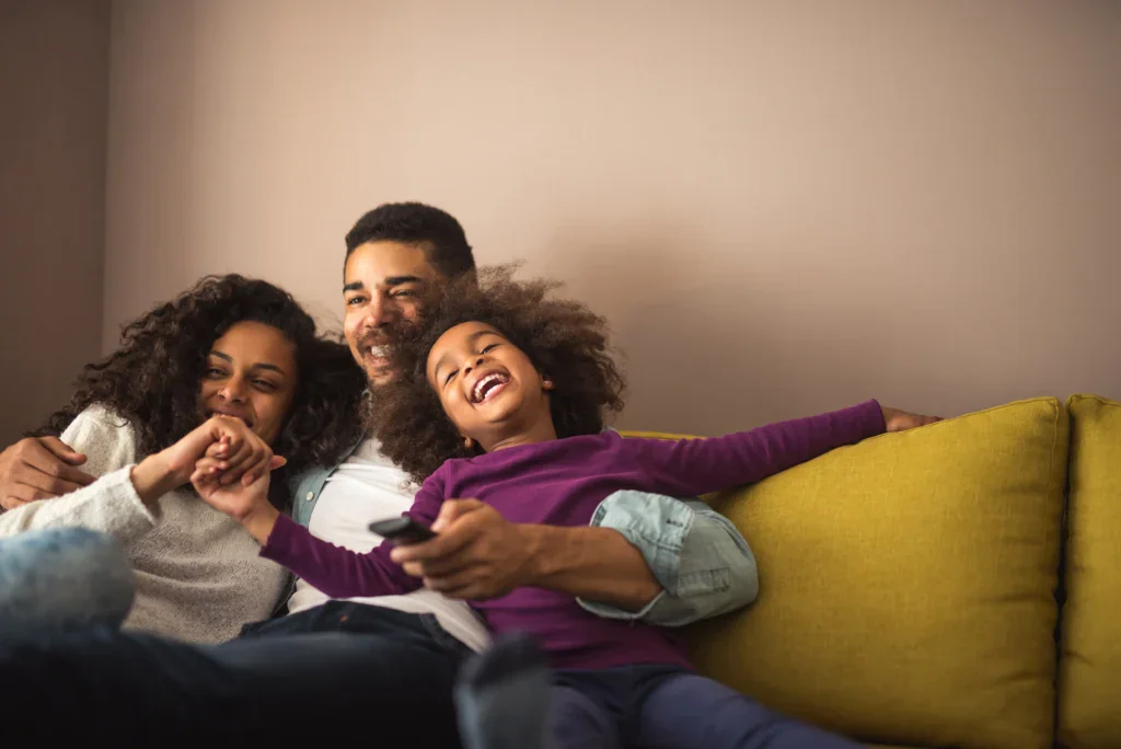 Young family smiling on couch