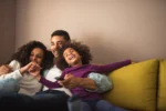 Young family smiling on couch