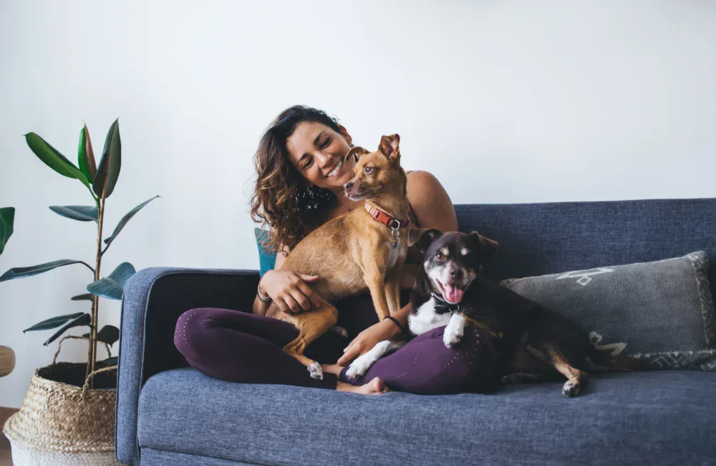 Young Woman with Two Dogs on couch