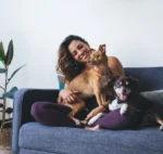 Young Woman with Two Dogs on couch