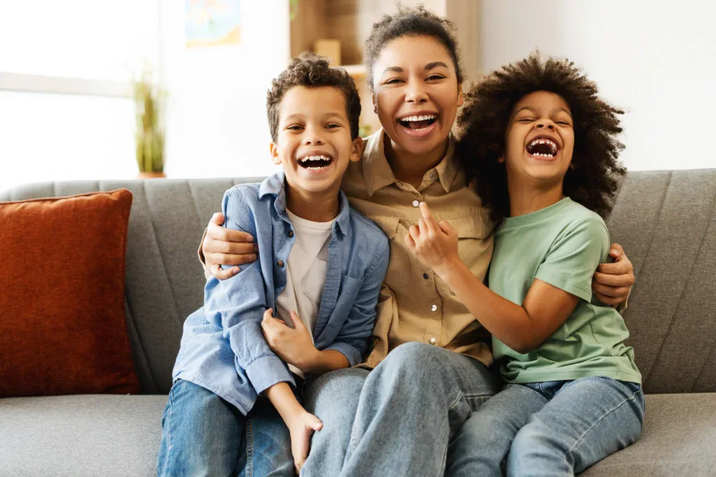 Family Smiling on Couch